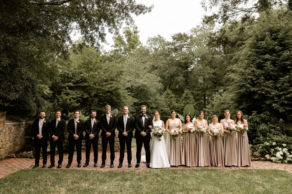 bridal party photos at elegant outdoor wedding venue