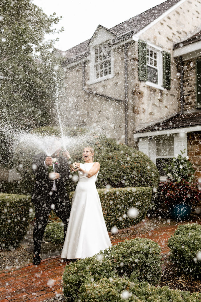 bride and groom champagne spray