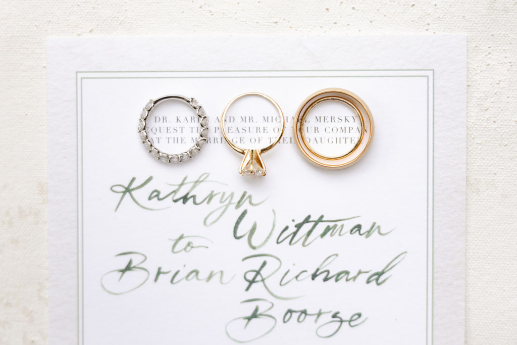 Wedding rings and wedding invitation flatlay detail shot