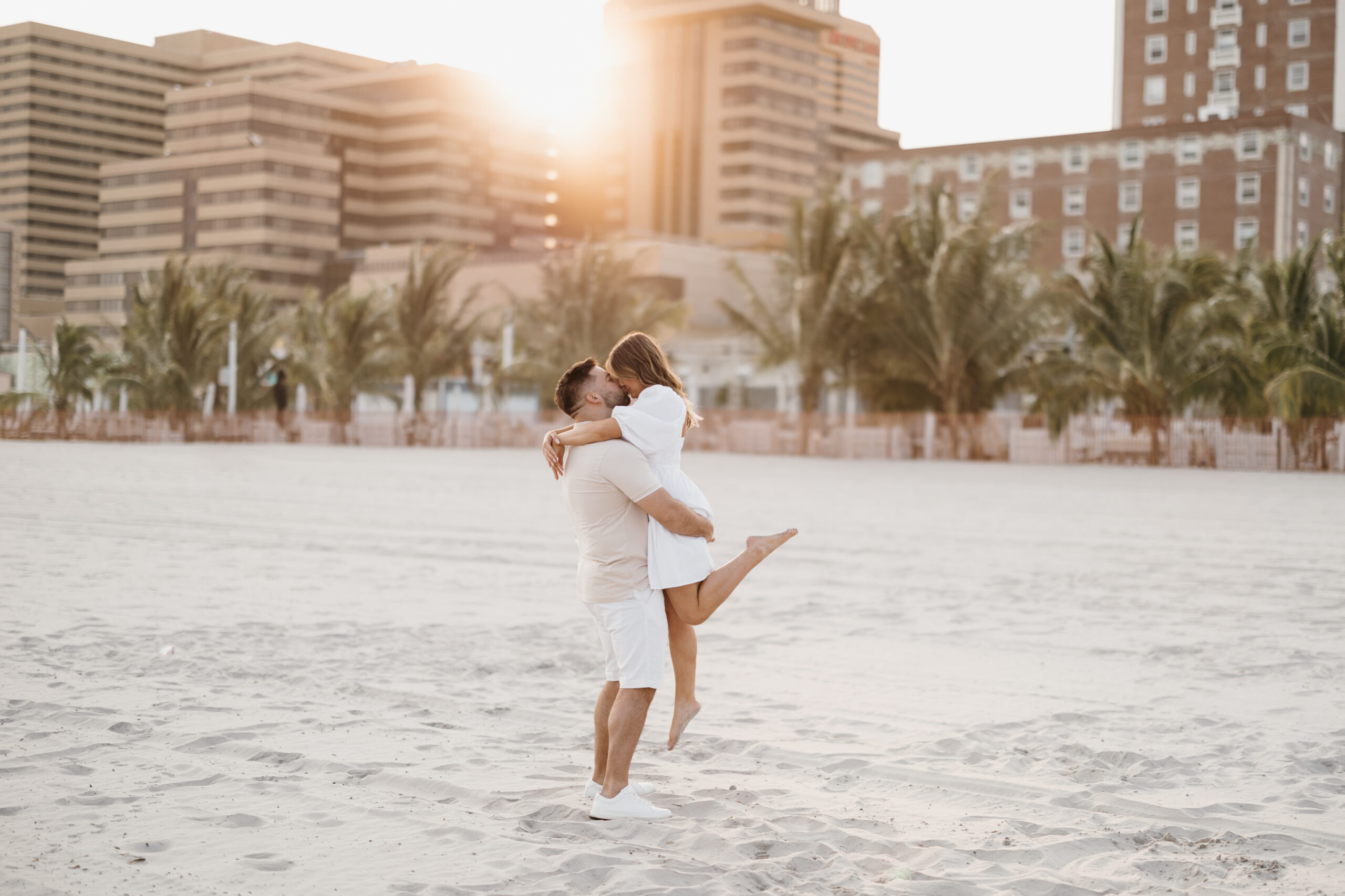 I just had the most amazing engagement photo session with this awesome couple, Alyssa and Vincent, and I can't wait to tell you all about it. We spent an evening in Atlantic City, and let me tell you, the sunset was absolutely breathtaking. The sky was painted with hues of orange, pink, and purple, creating the perfect backdrop for these lovebirds.